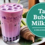 Glass of creamy purple taro bubble milk tea topped with tapioca pearls, surrounded by fresh taro roots and leaves, set in a cozy café background